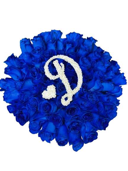 Heart-shaped arrangement of blue roses with a white letter 'D' in the center on a white background
