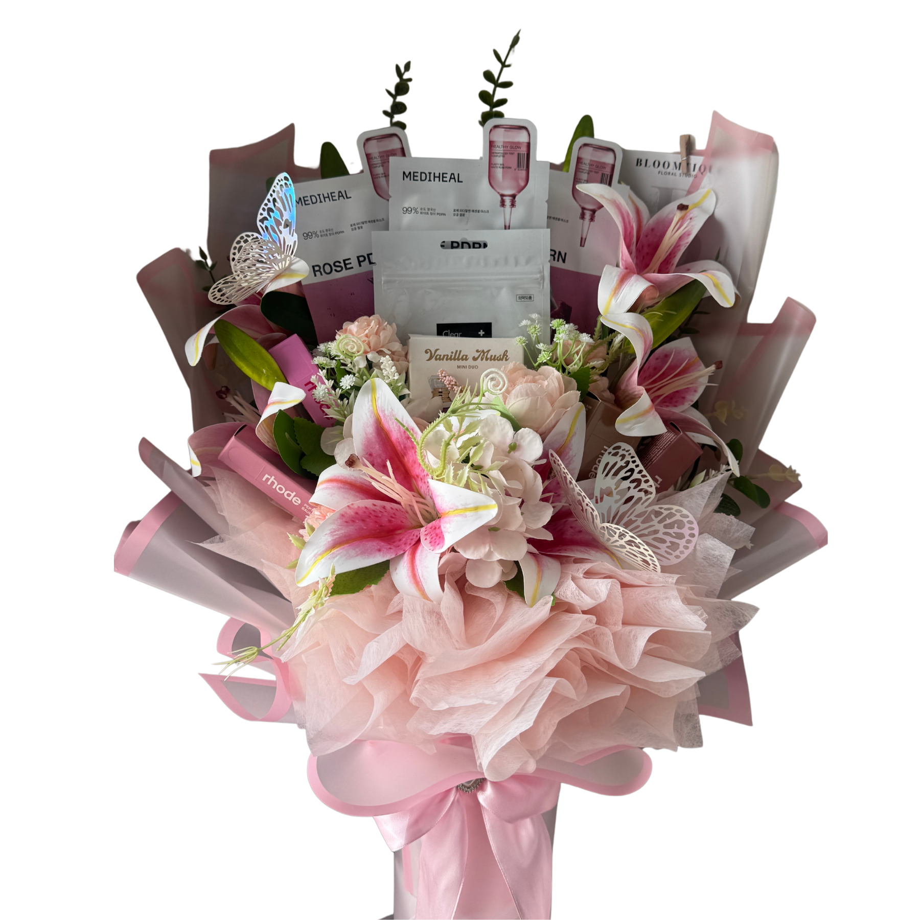 Bouquet of flowers with beauty products wrapped in it on a white background